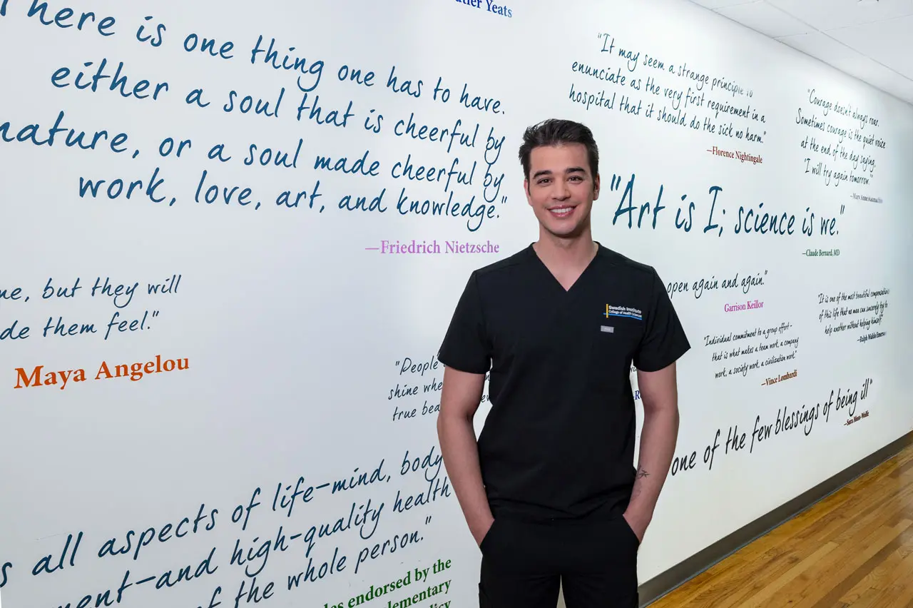 swedish institute student standing in front of a wall of inspiring quotes swedish institute student standing in front of a wall of inspiring quotes