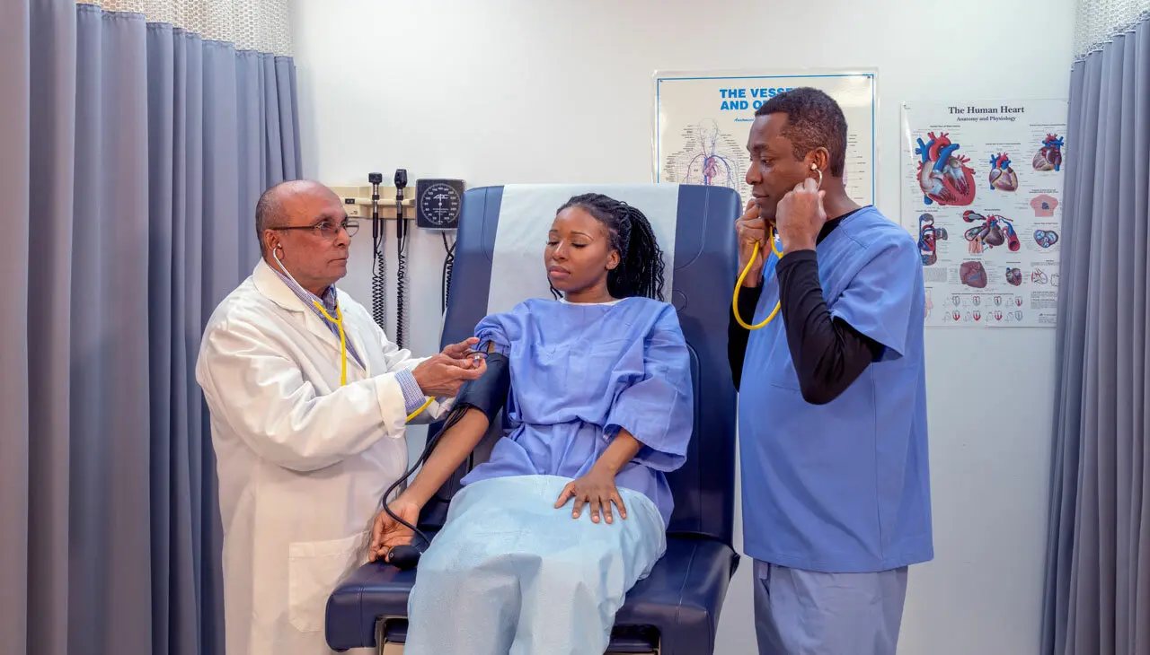medical assistant instructor and student attending to a patient