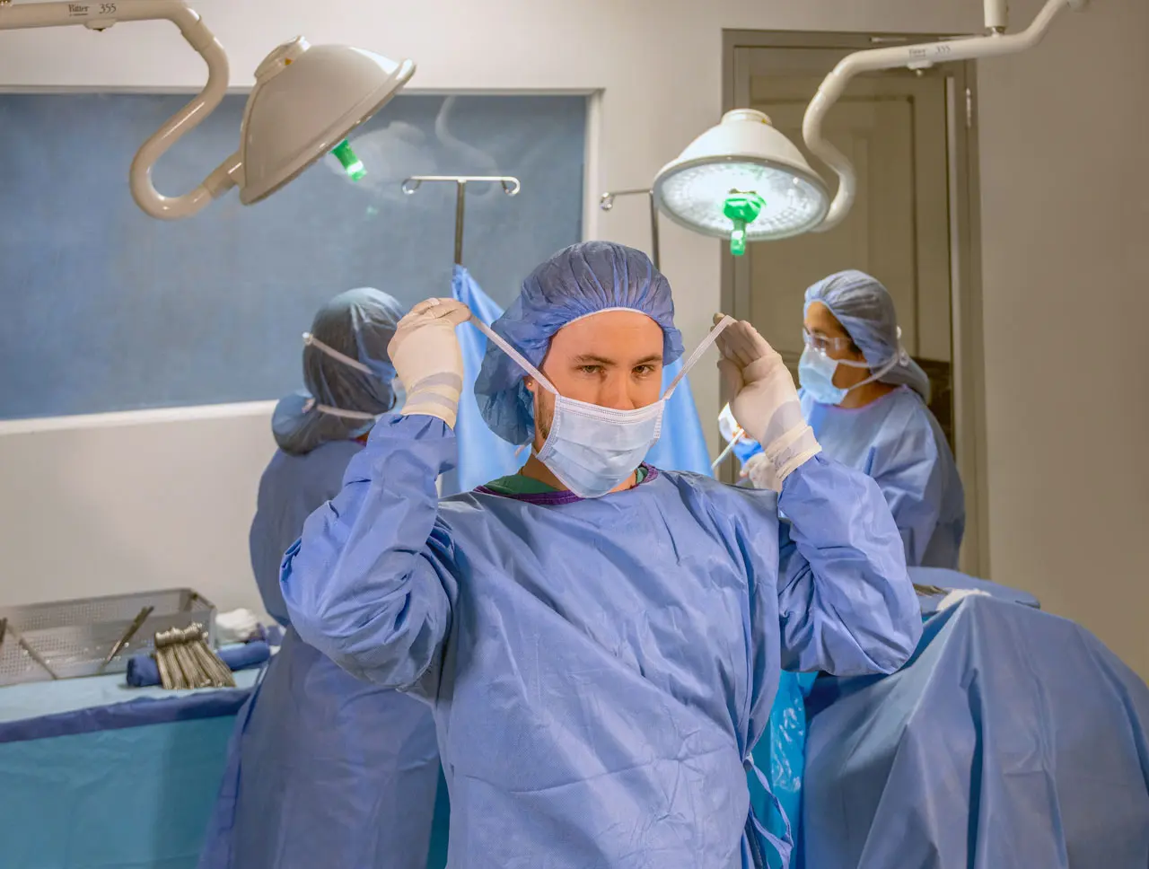 a surgical technologist wearing surgical gear preparing for surgery