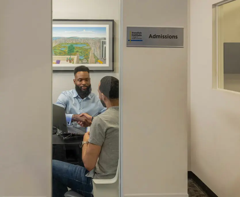 admissions counselor working with a new student
