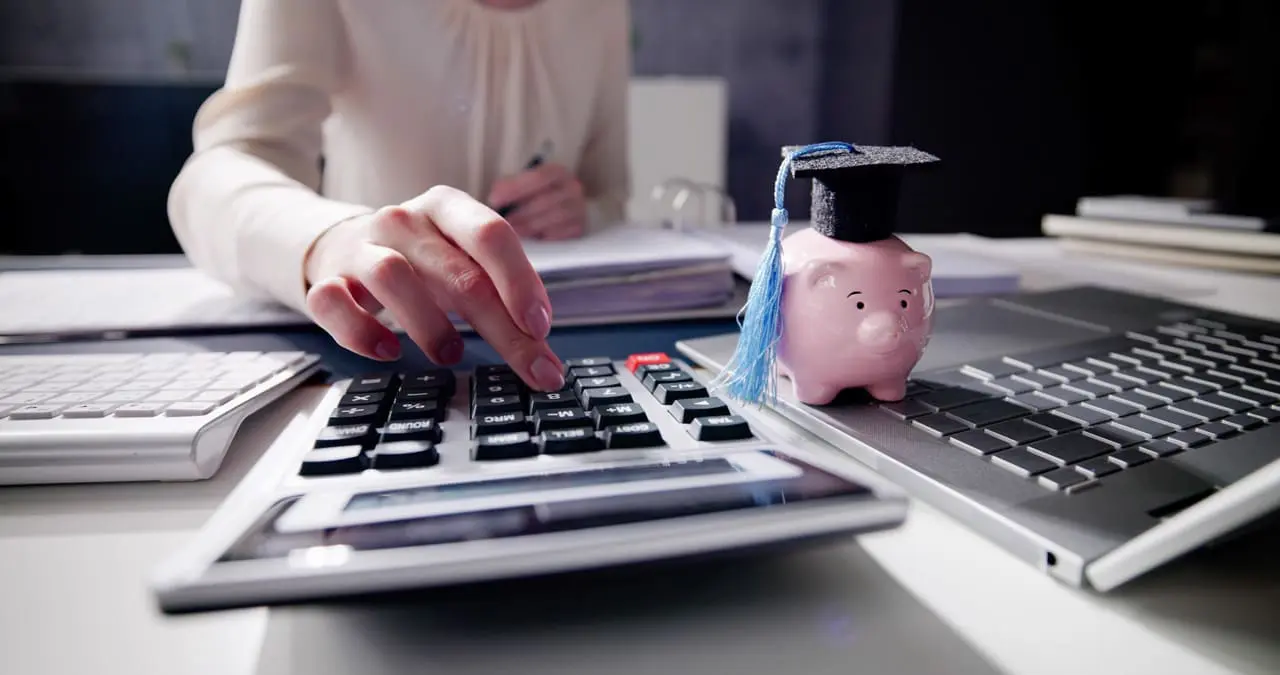 a woman at a desk using a calculator