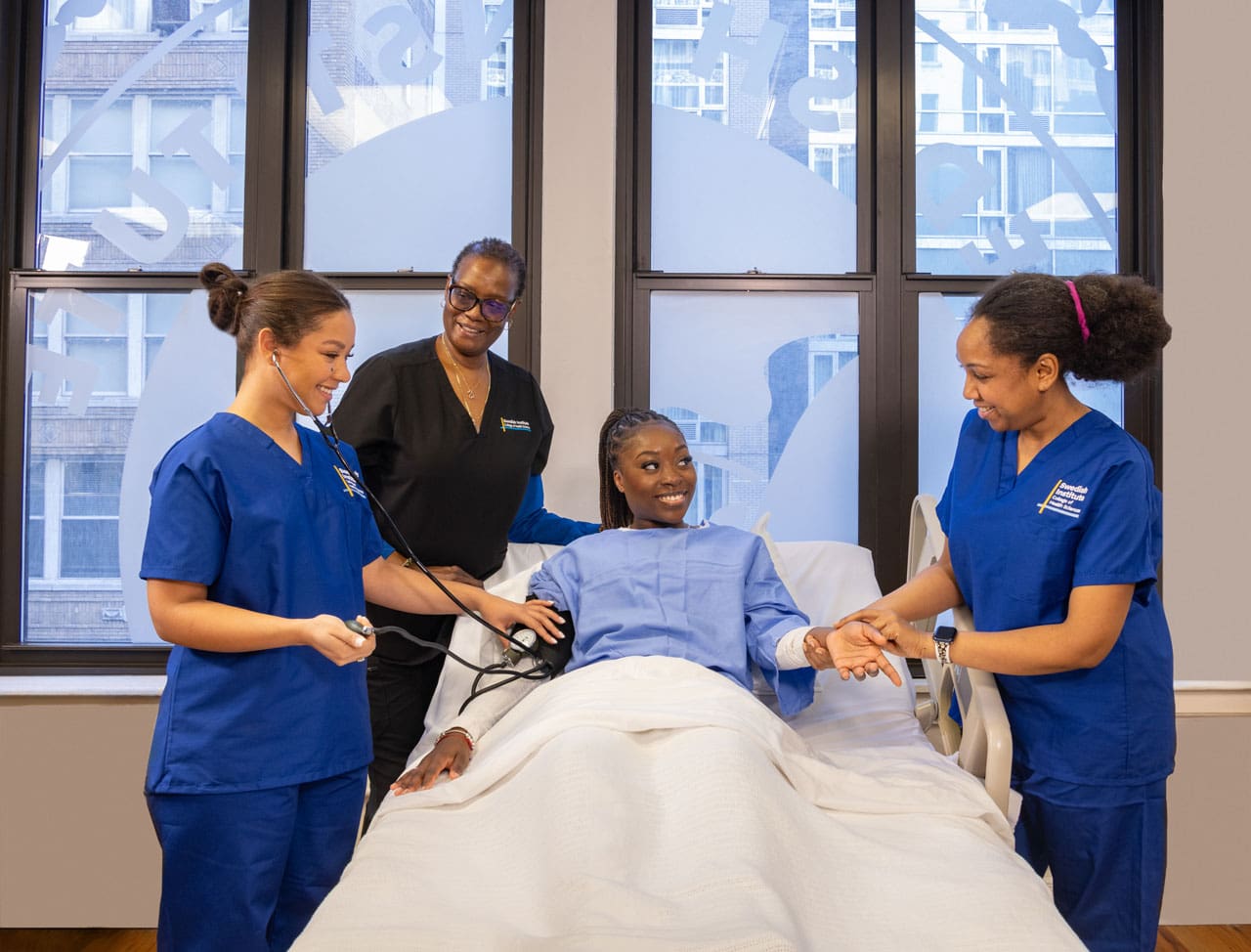 nursing program students helping a patient