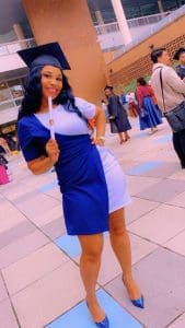 Carla Desrouleaux prouldy shows off her diploma from Swedish Institute. 