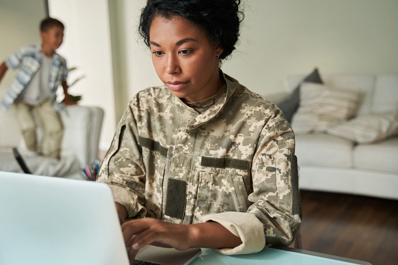 armed forces member working on computer
